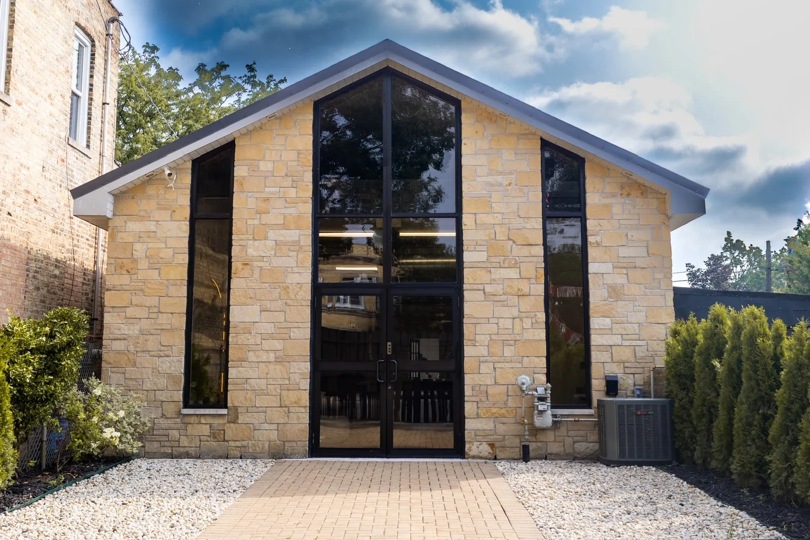 Front of MARPA Studio, a stone building with a gabled roof and tall windows on Chicago's Northwest Side