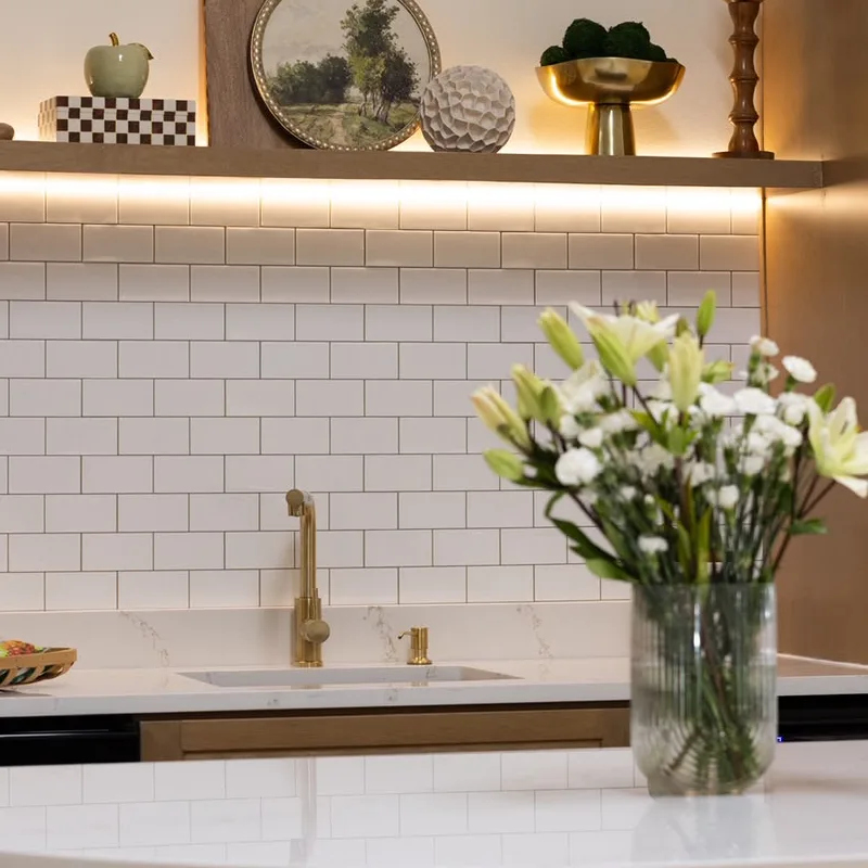 White lilies in a glass vase on the kitchenette island