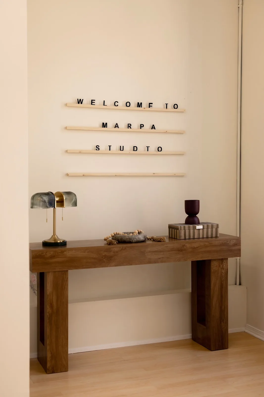 Wooden console under a letter board that reads Welcome to MARPA Studio
